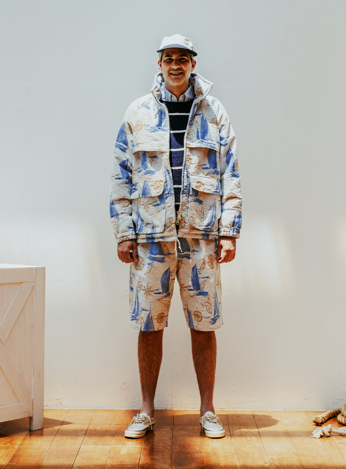 Model wearing a colorful jacket and shorts set.