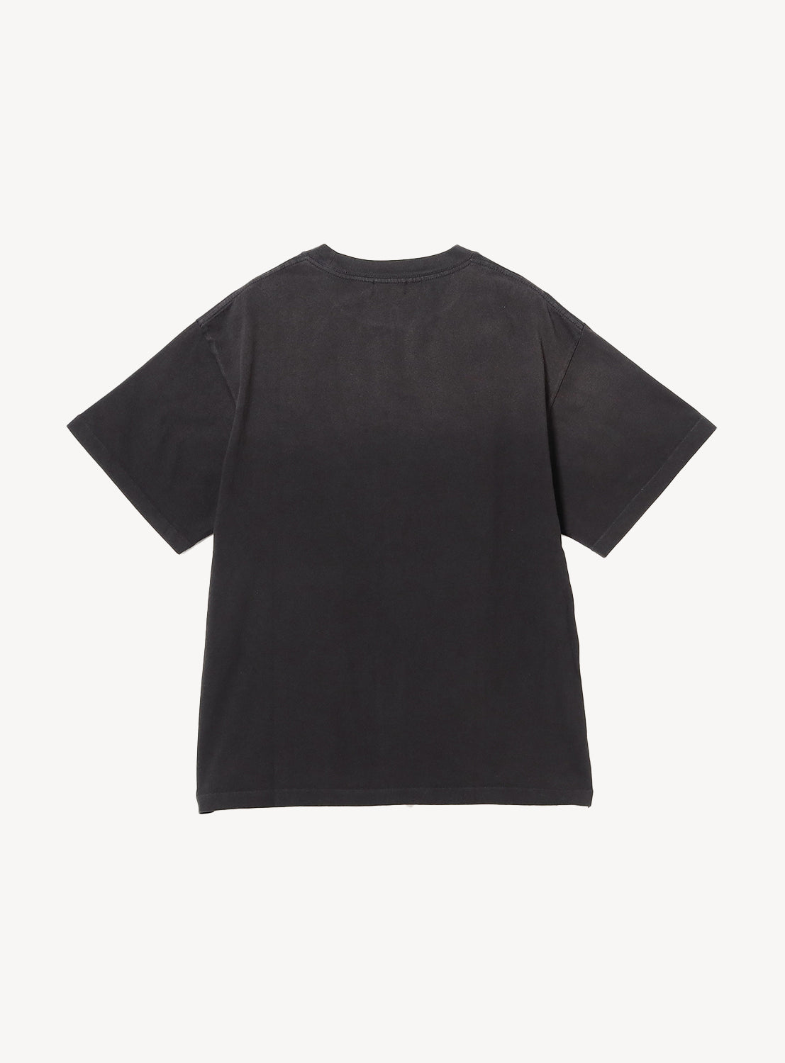 Black of a plain black t-shirt with light fading on the top of the shirt.