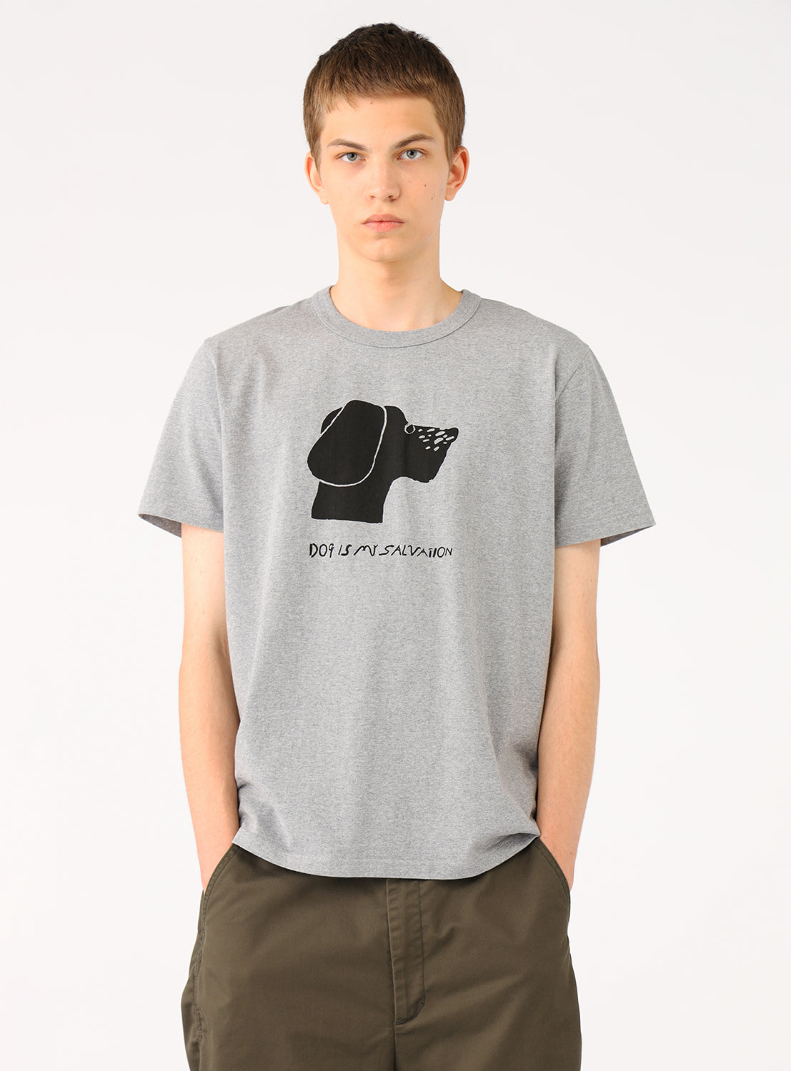 Model wearing a light grey t-shirt with a dog face graphic.