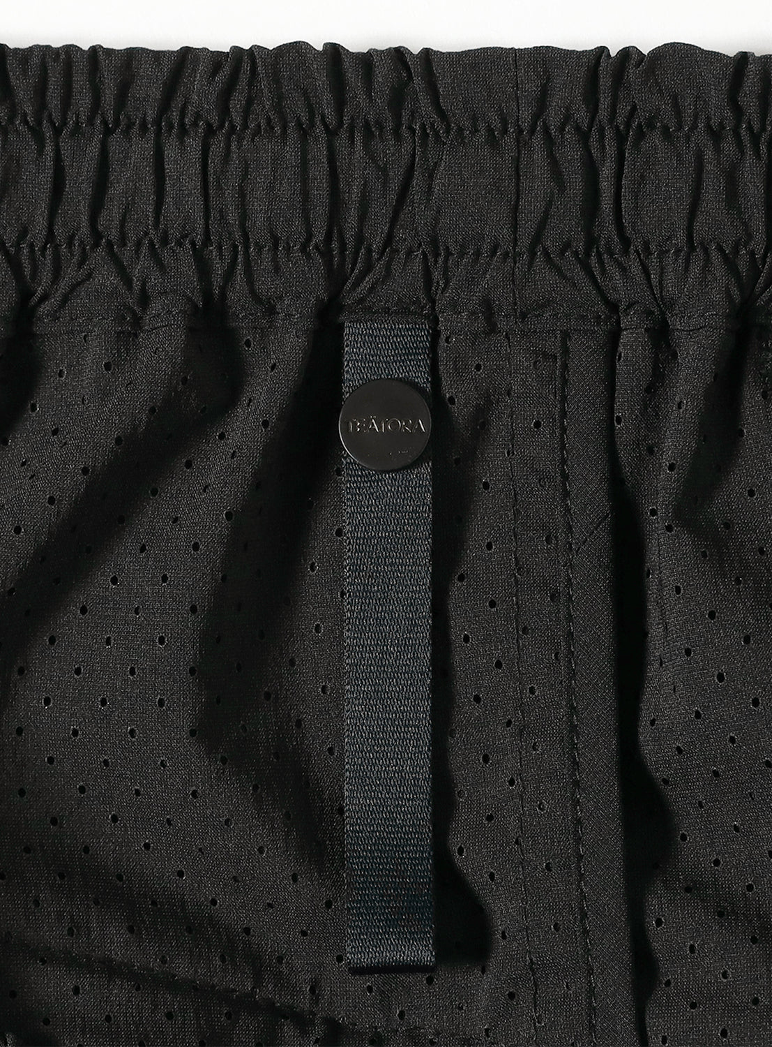 Close-up of the pants' Hybrid Waistband, highlighting the DOCTOROID fabric and heat-dispersing mesh.