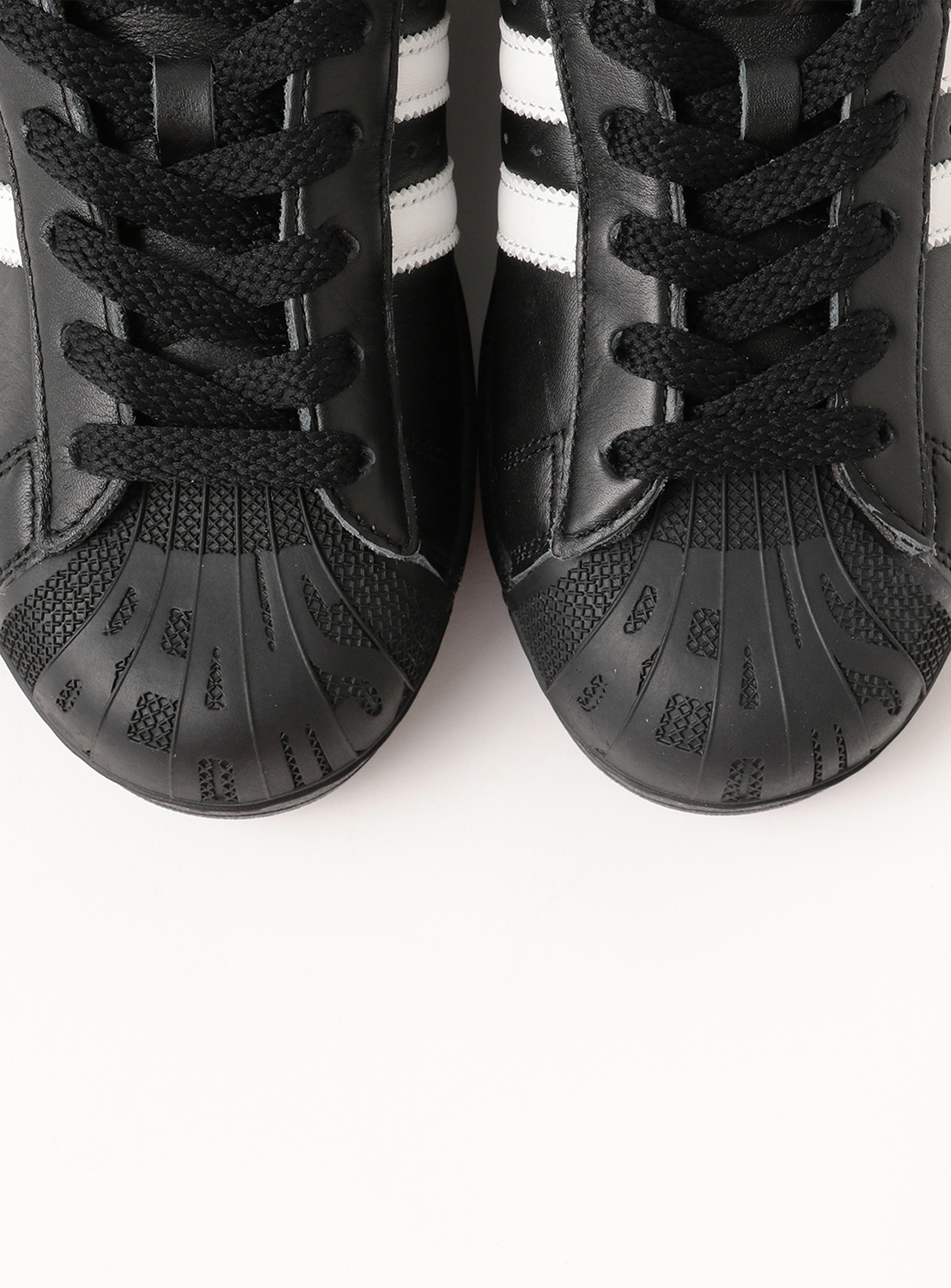 Exclusive adidas SUPERSTAR II Black men’s sneakers by adidas, viewed from above against a white background, display white stripes, laces, and textured rubber toe caps.