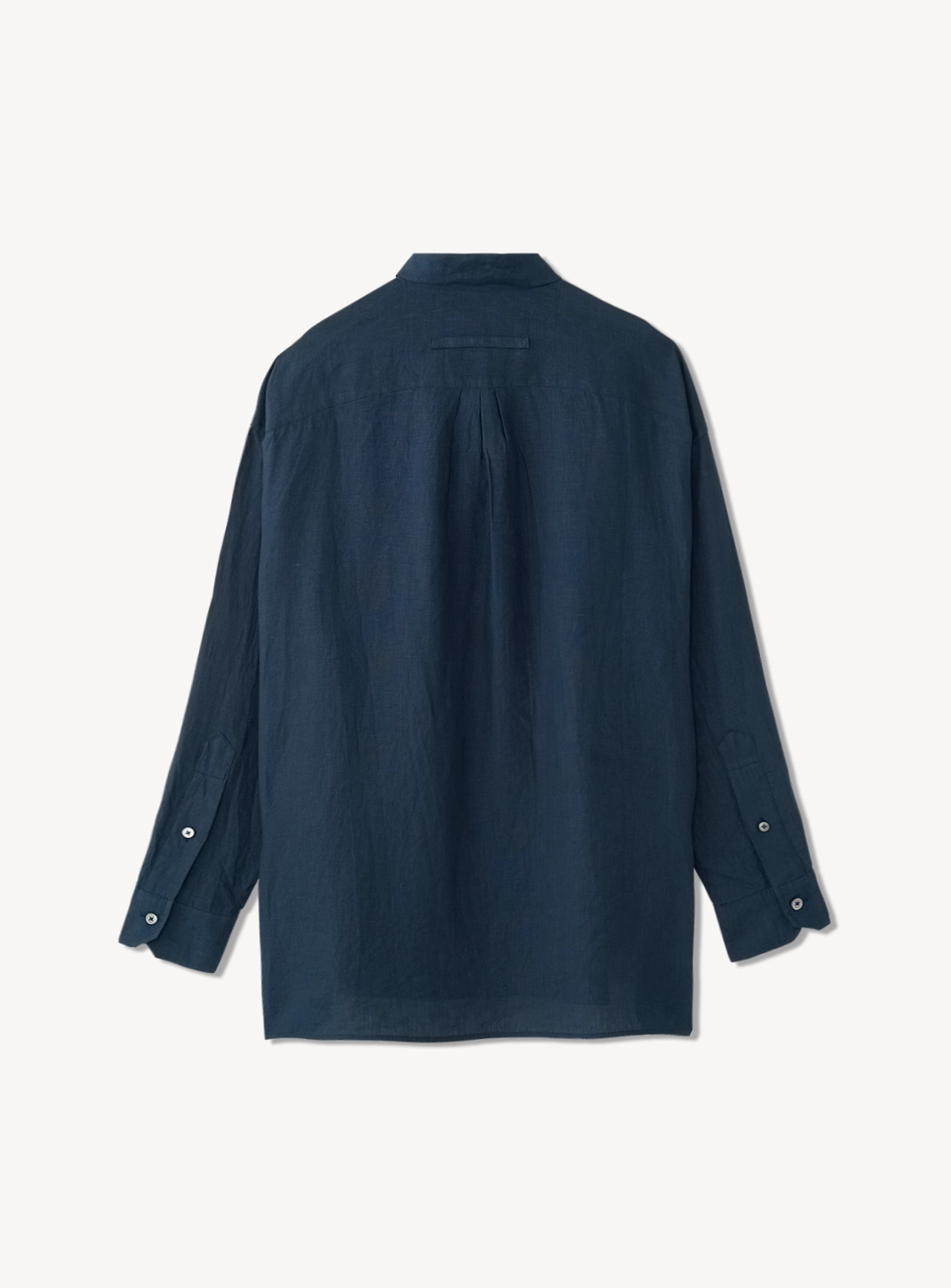 Back of navy blue button down shirt featuring two buttons on the sleeves.