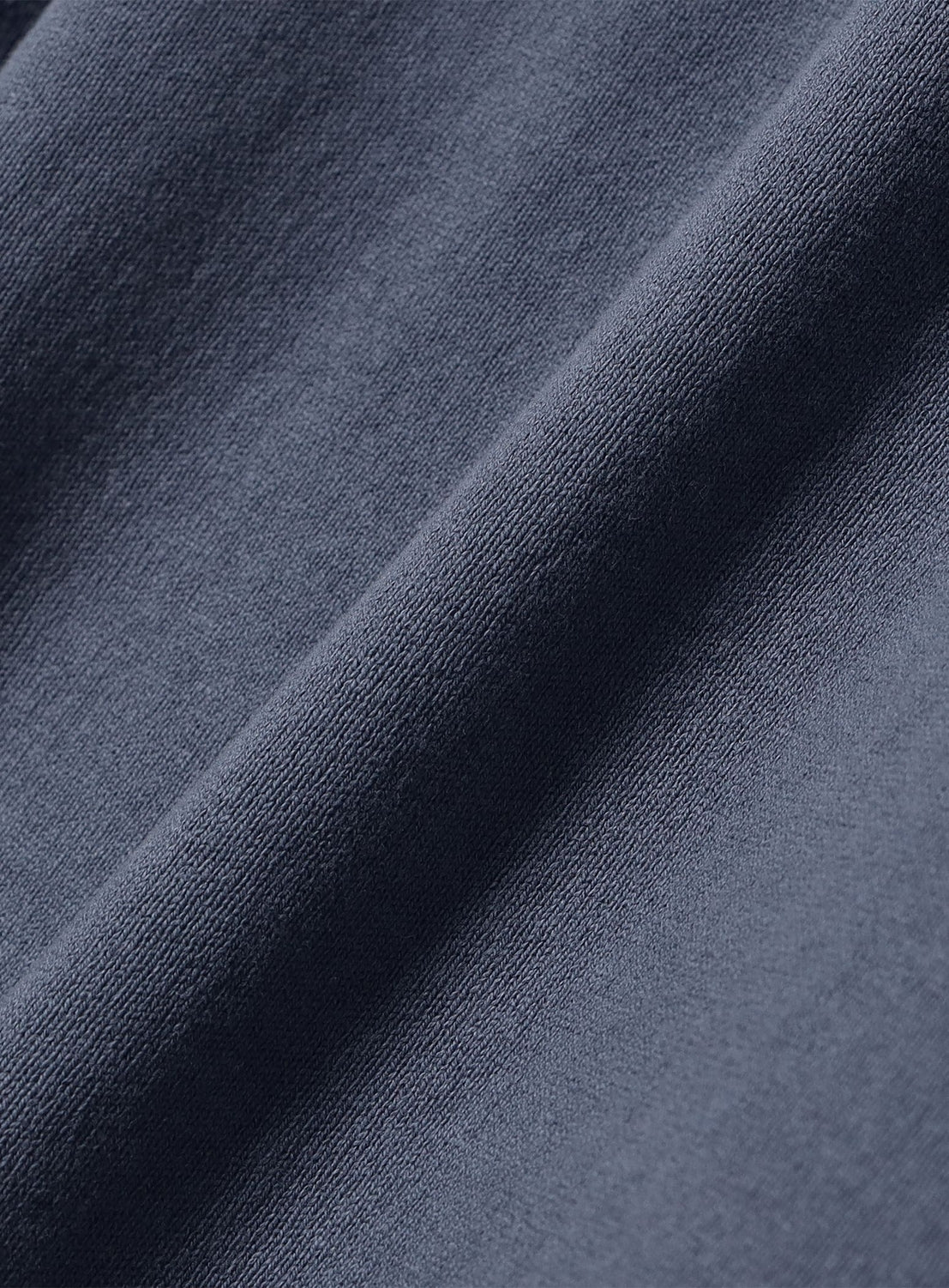 Close-up of a dark grey BEAMS Garment-Dyed Rugby Shirt in heavyweight cotton jersey with a visible diagonal fold.