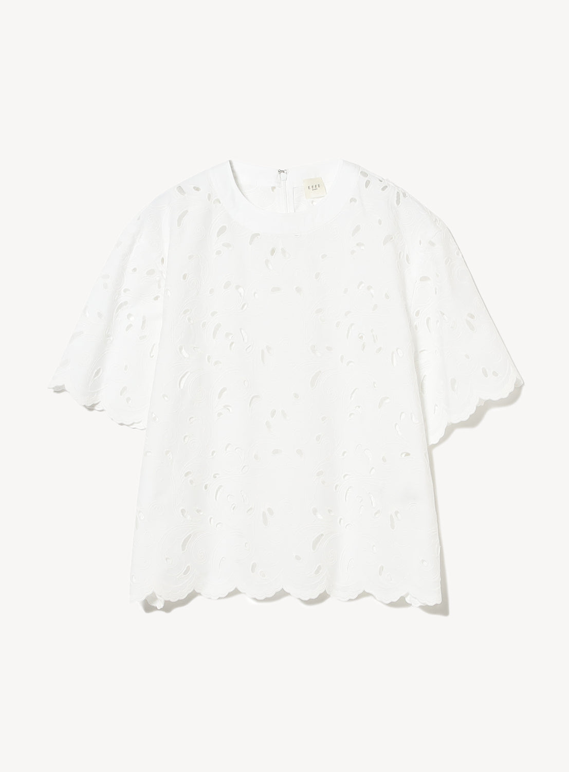 White boxy-fit blouse from EFFE BEAMS with delicate leaf-patterned cutwork embroidery.