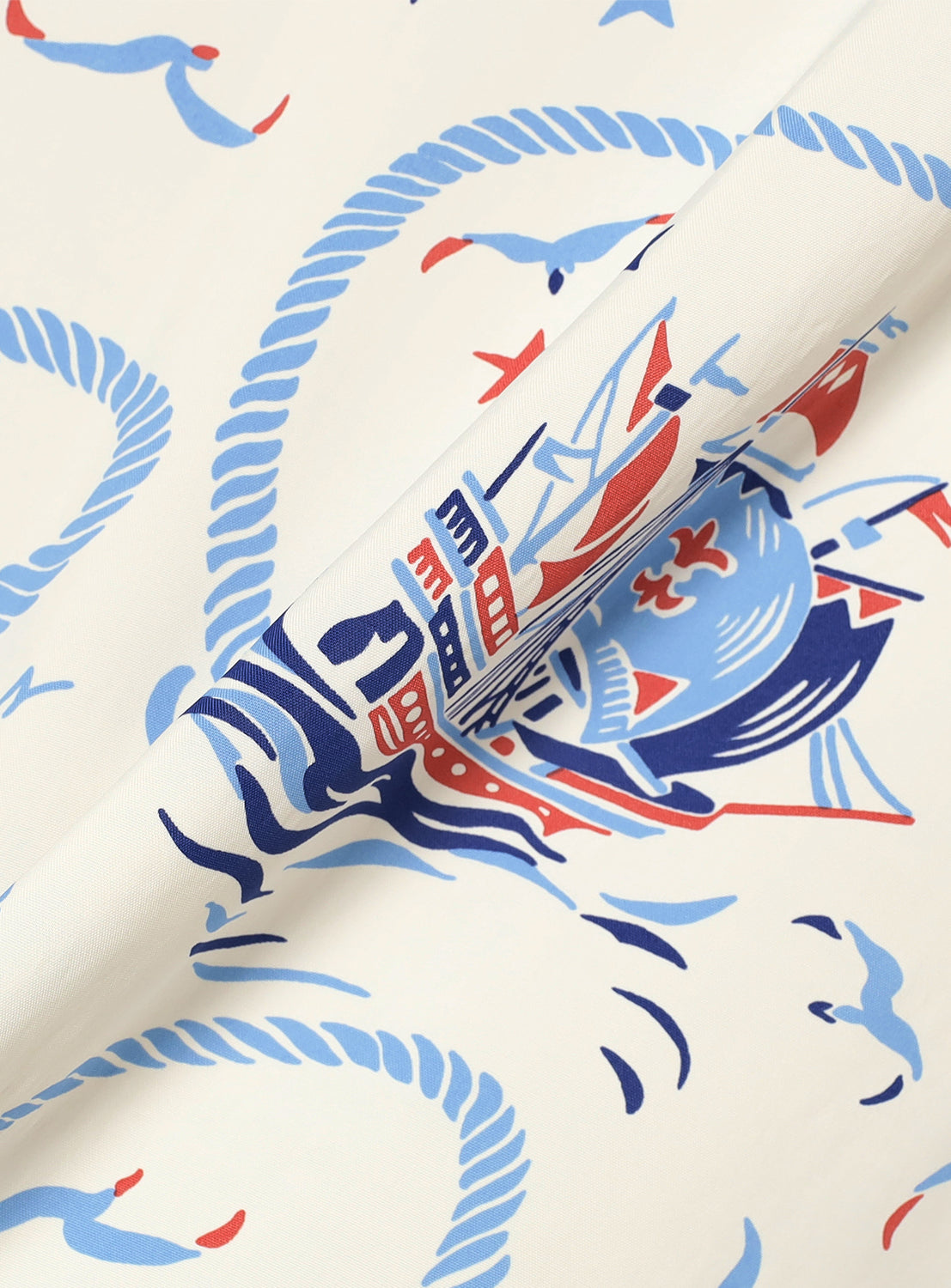  white patterned fabric, revealing the detailed nautical rope and compass print.