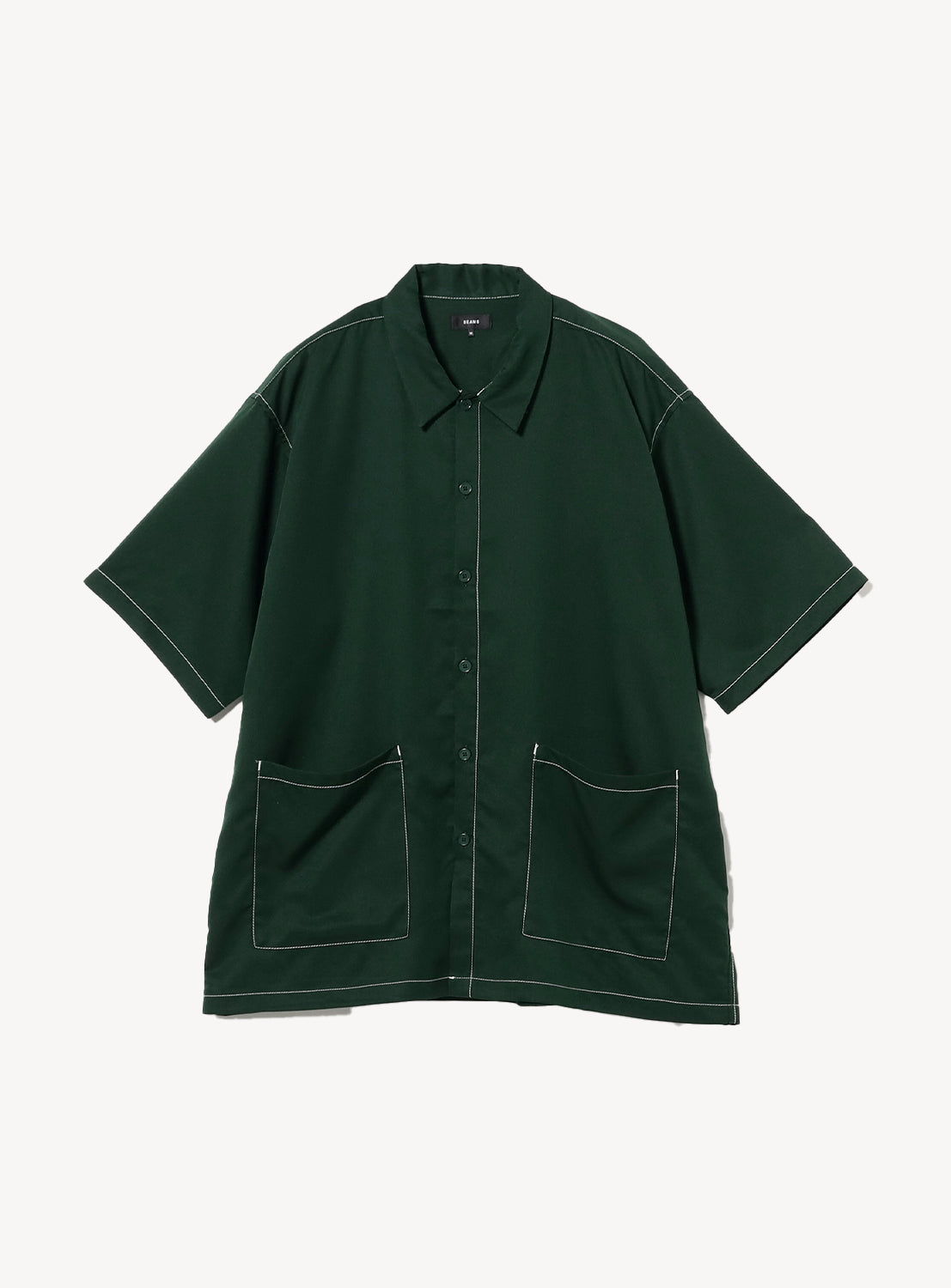 Flat lay of the BEAMS Stitching Easy Shirt in dark green, featuring a minimalist design with subtle, color-coordinated stitching and an oversized waist pocket. 