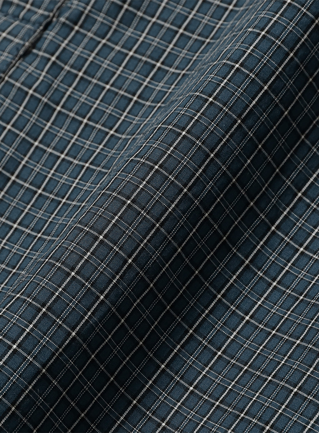 Close-up of navy blue fine check-patterned typewriter cloth, detailing the fabric texture and subtle pattern.
