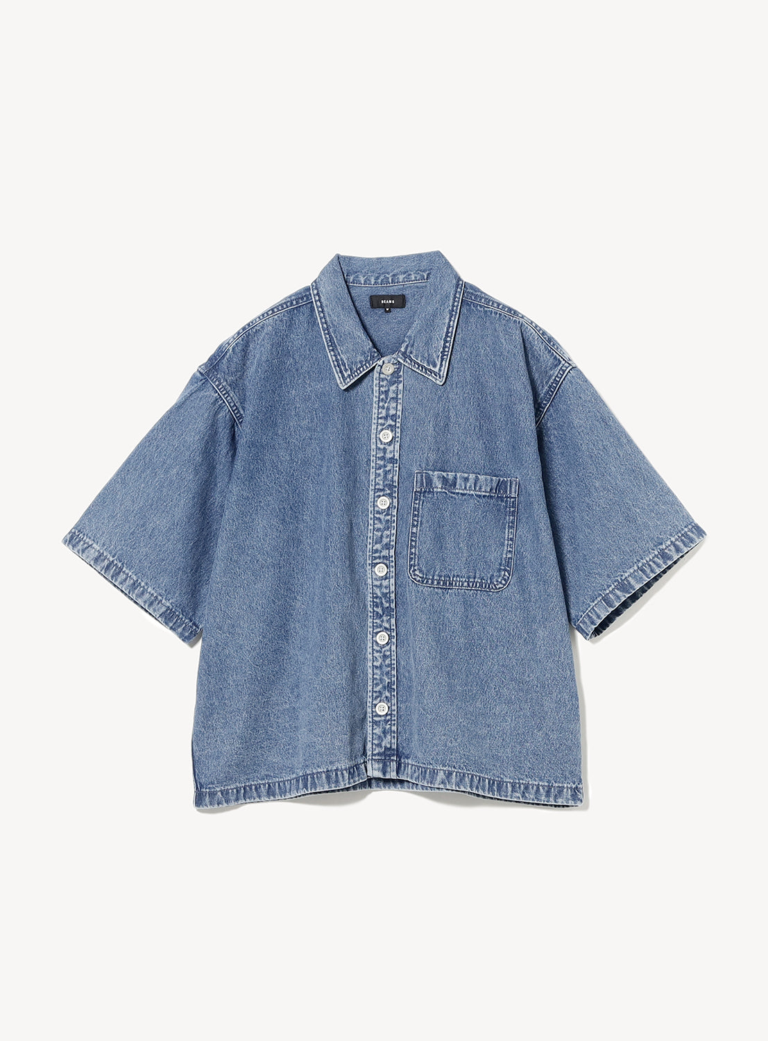 Flat lay of BEAMS Short Denim Shirt in blue indigo denim with open camp collar, short sleeves, oversized chest pockets, and relaxed boxy fit.