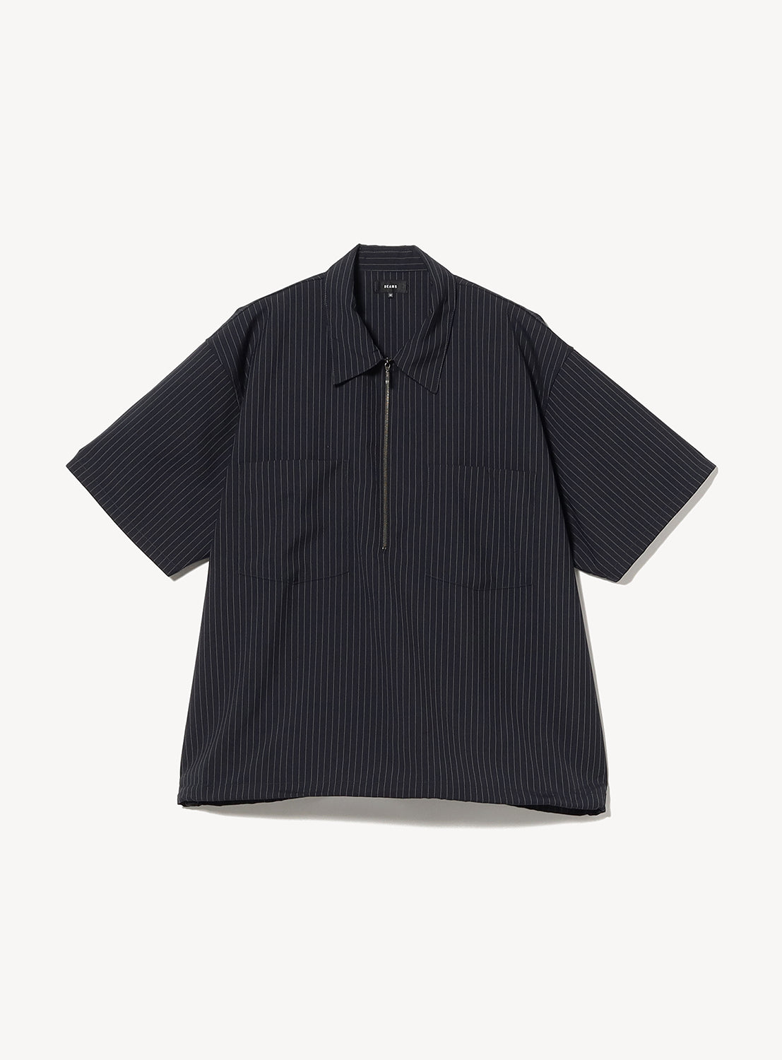 The BEAMS TW Wide Fit Half-Zip Shirt is a short-sleeve black pinstripe pullover featuring a collar and partial front zipper, crafted from lightweight polyester-wool tropical fabric. Displayed flat against a white background, its relaxed silhouette offers both style and comfort.