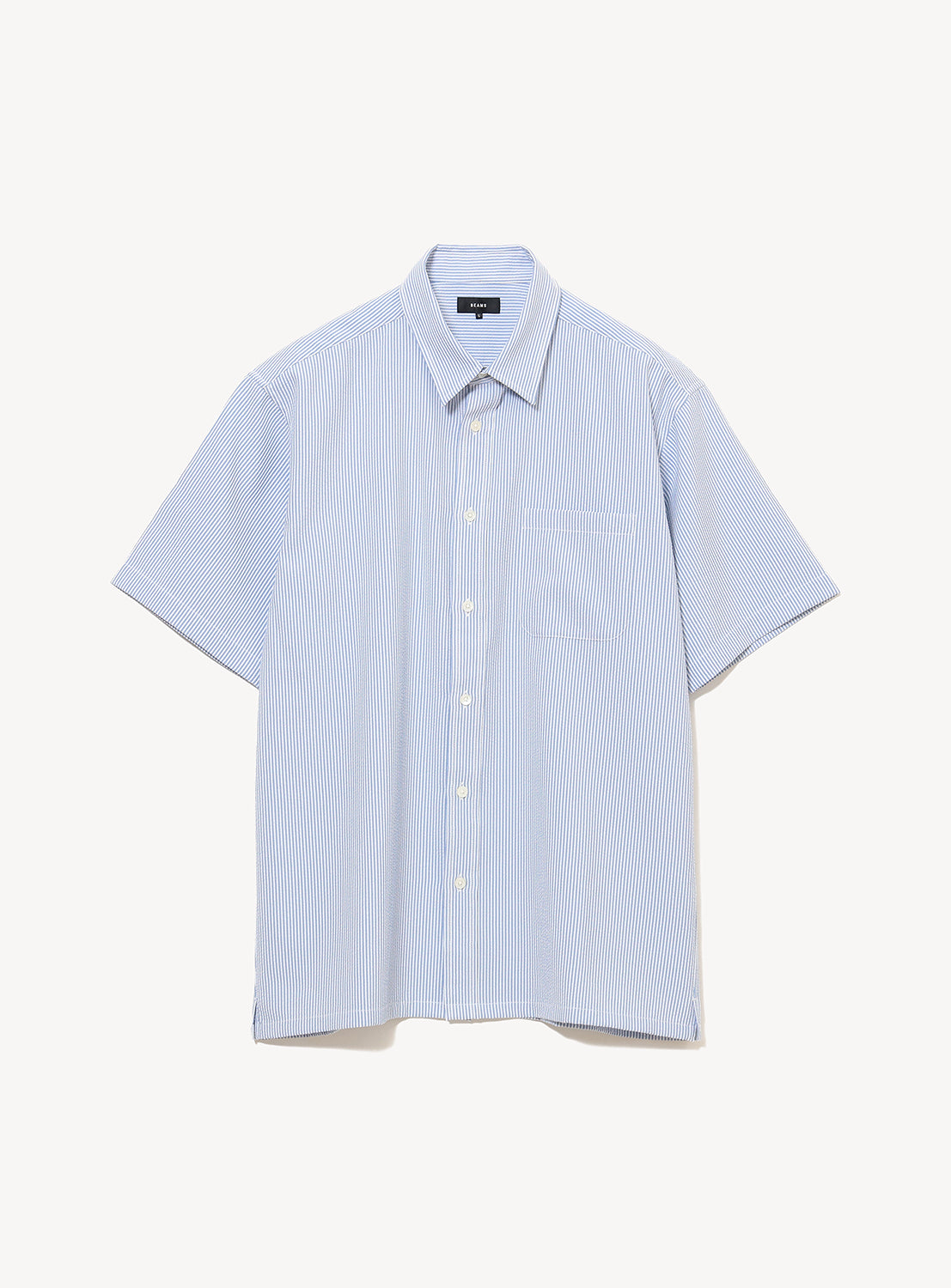The BEAMS Stretch Quick-Dry Seersucker Relaxed Fit Shirt is a light blue, lightweight short-sleeve button-up with thin white vertical stripes, featuring a classic collar and chest pocket, displayed against a plain white background.