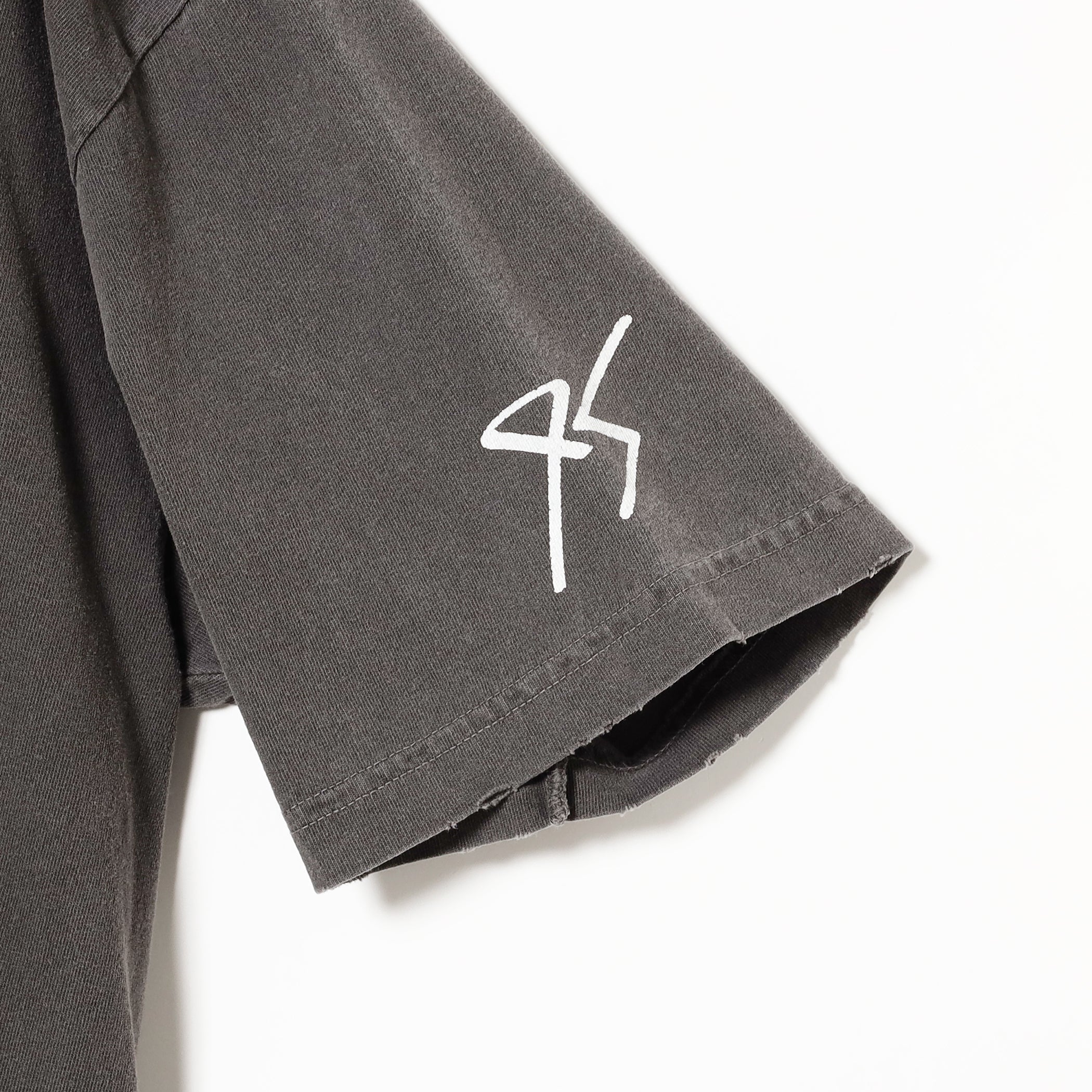 T-shirt sleeve detail showing a subtle 95 stylized graphic.