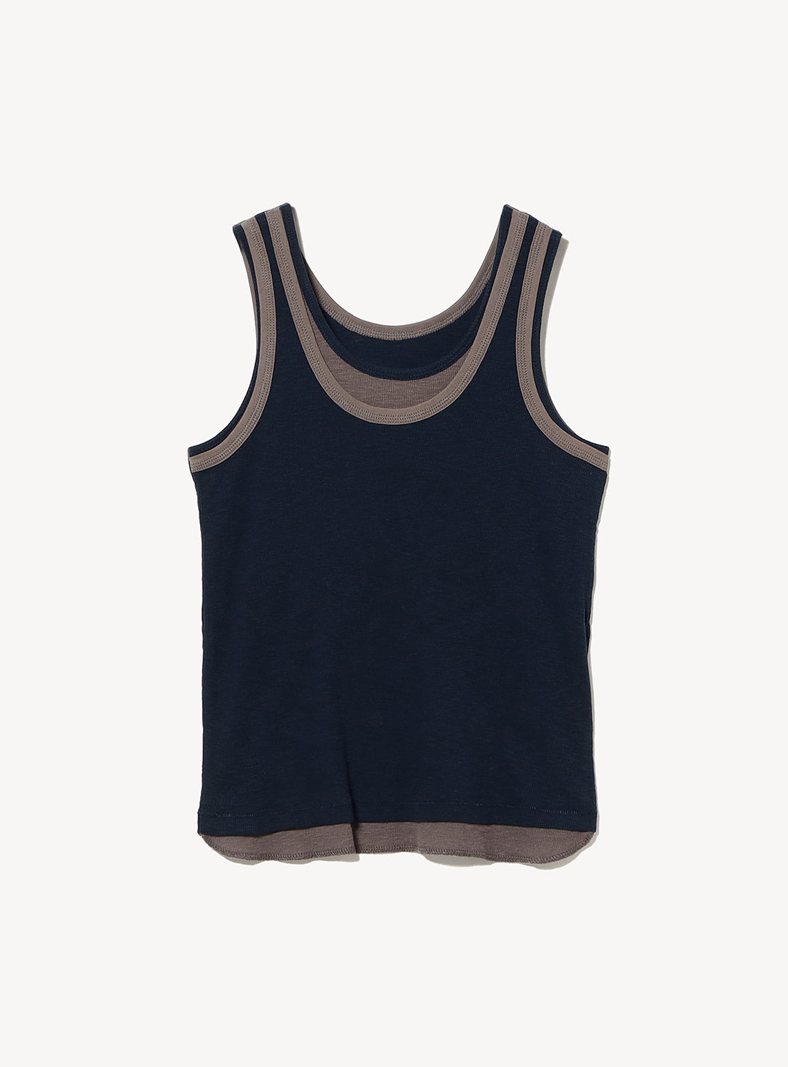 The BEAMS BOY Layered Rib Tank Top is a sleeveless navy blue ribbed knit tank featuring beige trim around the neckline and armholes, shown laid flat on a white background.