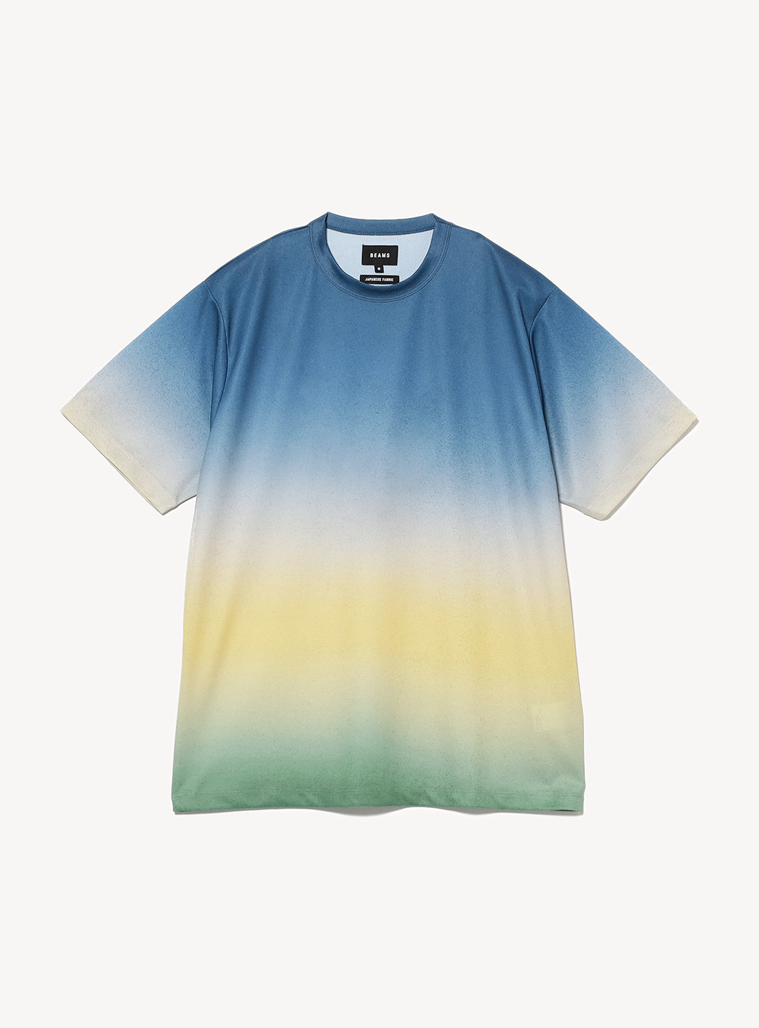 Blue to yellow to green gradient t-shirt flat lay, showcasing its unique faded color transition.