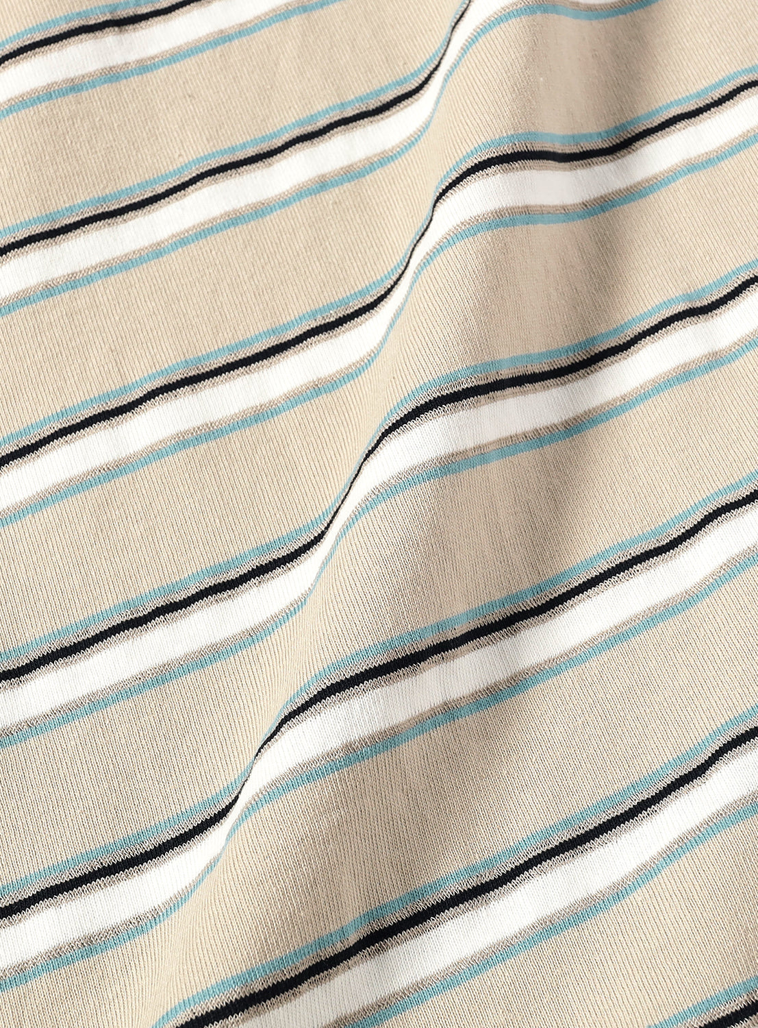 beige fabric, revealing the subtle ribbed texture and blue and white stripes.