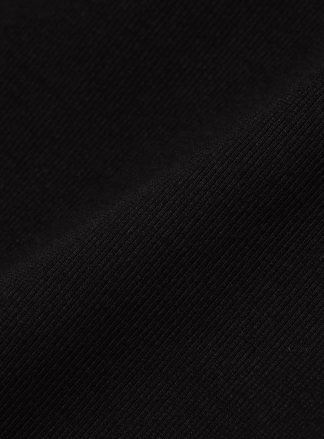 Close-up of the black knit fabric, revealing the distinct ribbed pattern.