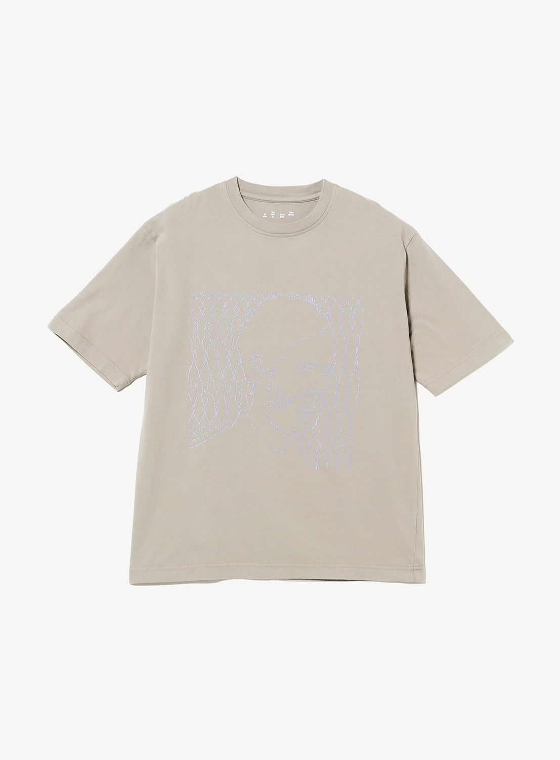 The IG The Prophet T-shirt by BAL is a beige, short-sleeve graphic tee with a relaxed fit. It features a subtle abstract outlined face and wavy lines in light blue printed on the front.