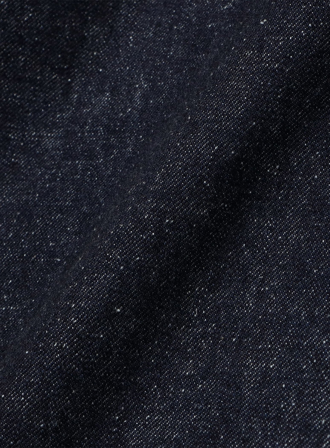 Close-up of BEAMS Wide Fit Denim Pants in 13oz cotton with a dark, subtle speckled texture.