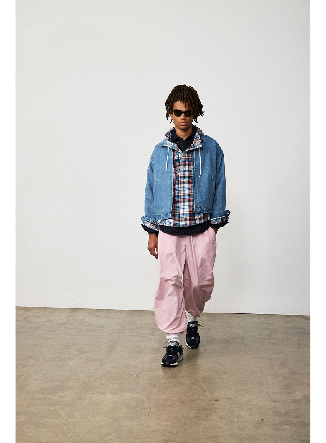 A person wearing a BEAMS Nep Denim Zip Jacket over a plaid button-down shirt, pink trousers, and dark sneakers.