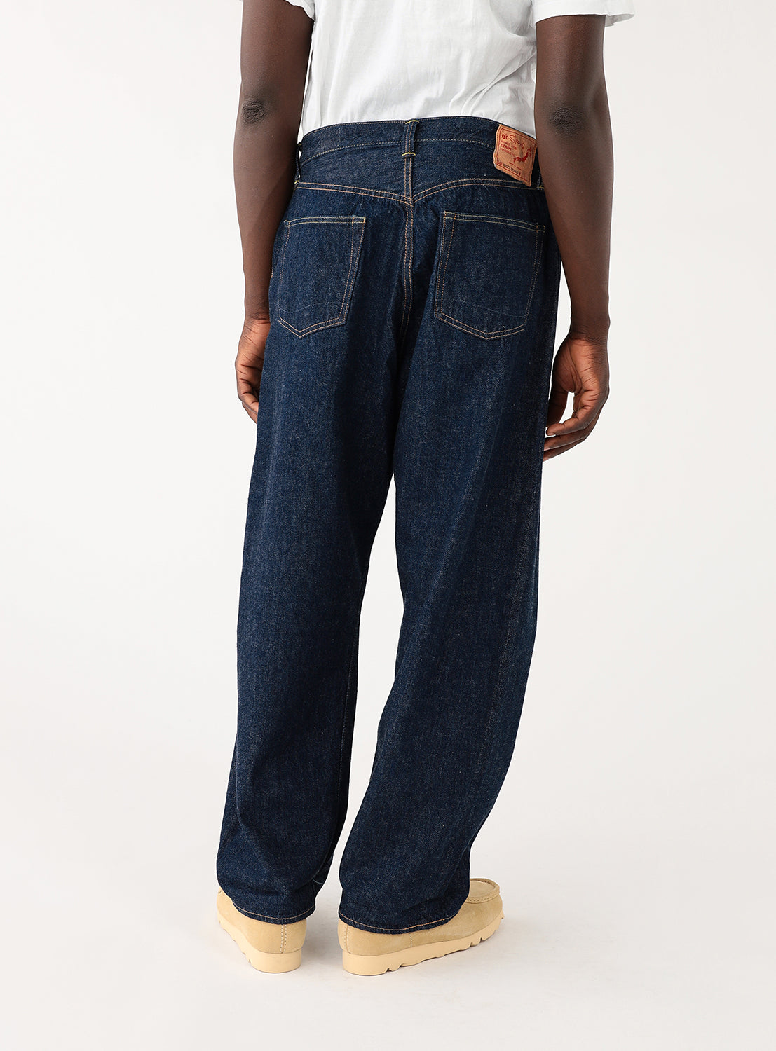 Back of Exclusive orSlow x BEAMS JAPAN 100 Super Dad jeans on a model. Relaxed fit, light-weight selvedge denim pants in classic indigo, Japanese craftsmanship, vintage-inspired wide leg silhouette.