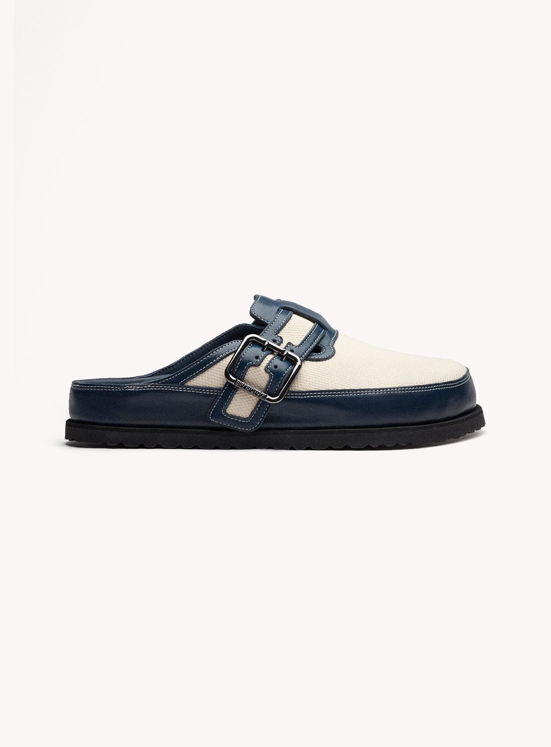 Navy and white slip-on shoe with a buckle on a white background