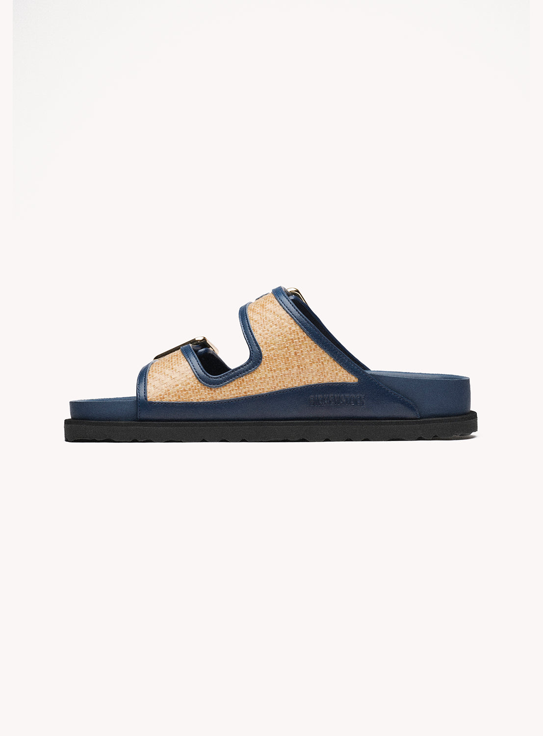 Navy sandal with woven strap on a white background