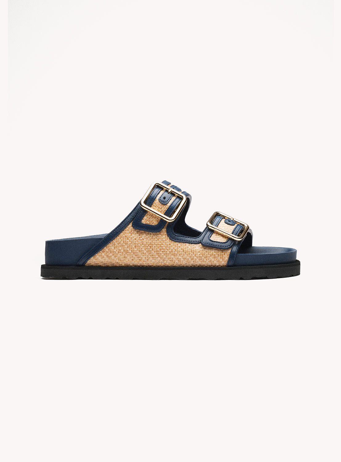 Navy sandal with gold buckles on a white background