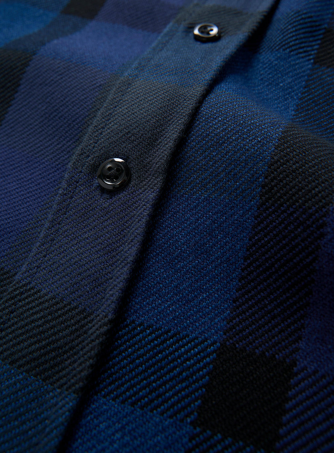 Close-up of the BEAMS Indigo Check Shirt, a blue and black relaxed fit button-up featuring two visible black buttons along the center placket.