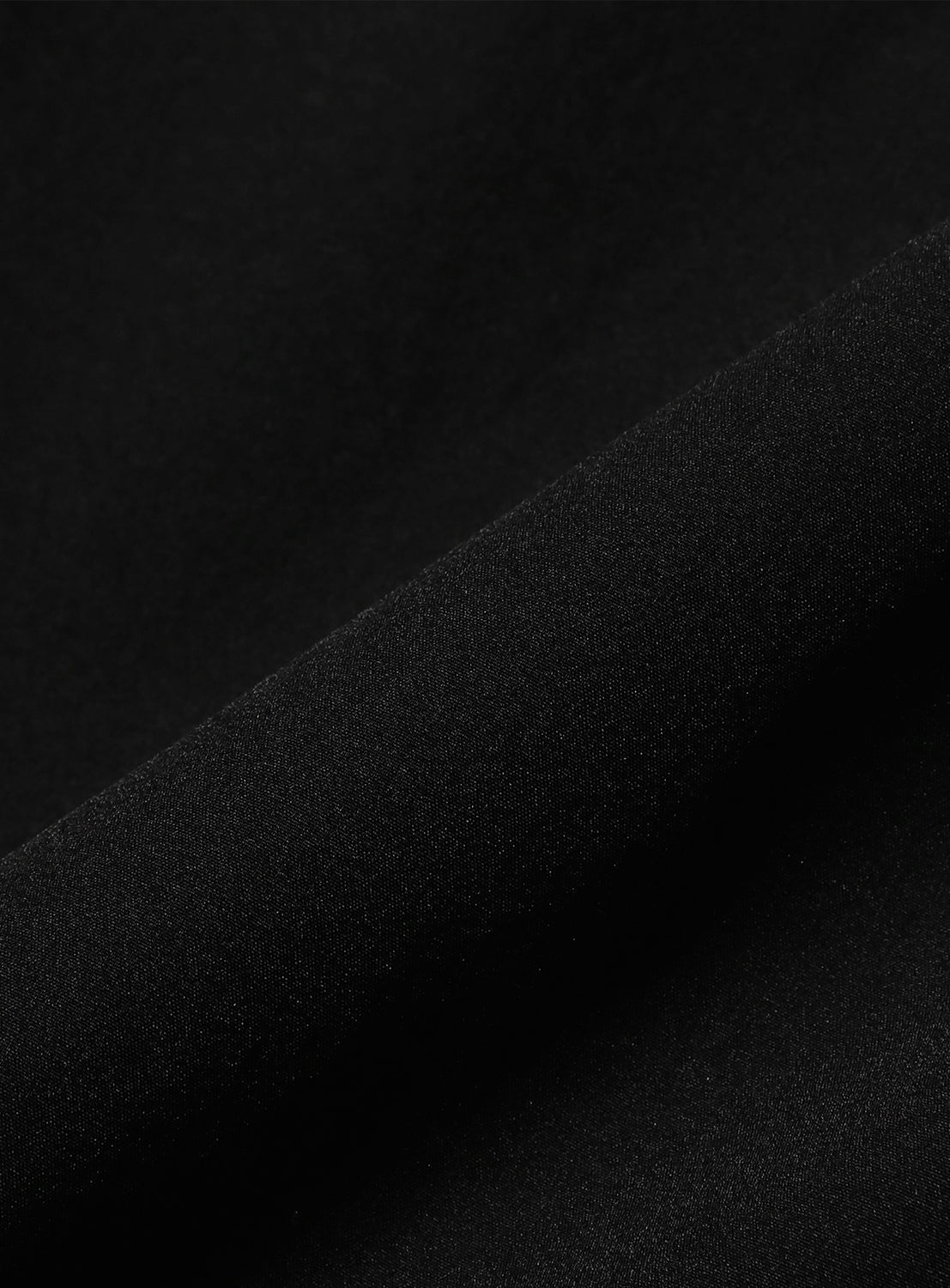 Black fabric, revealing a smooth material. 