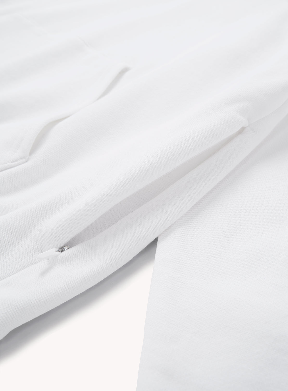 Close-up of the A - Suvin Turi Hoodie by BEAMS, featuring the side pocket and sleeve, and showcasing the premium cotton texture and meticulous stitching details.