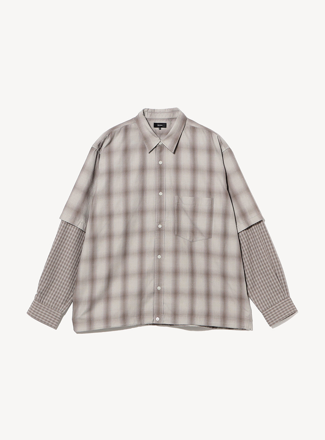BEAMS Layered Check Shirt, a wide-fit, faux-layered button-down featuring a large, soft-focus gray check pattern on the bodice and a smaller, distinct grid pattern on the sleeves.
