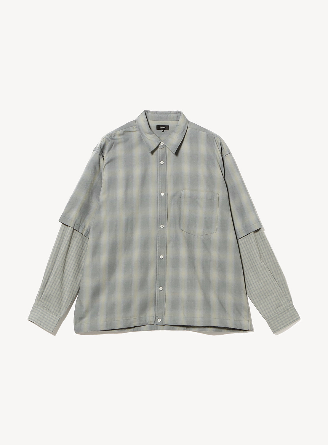 BEAMS Layered Check Shirt, a wide-fit, long-sleeve button-down with a faux-layered effect, a grey plaid pattern on the body and sleeves, and a small chest pocket.