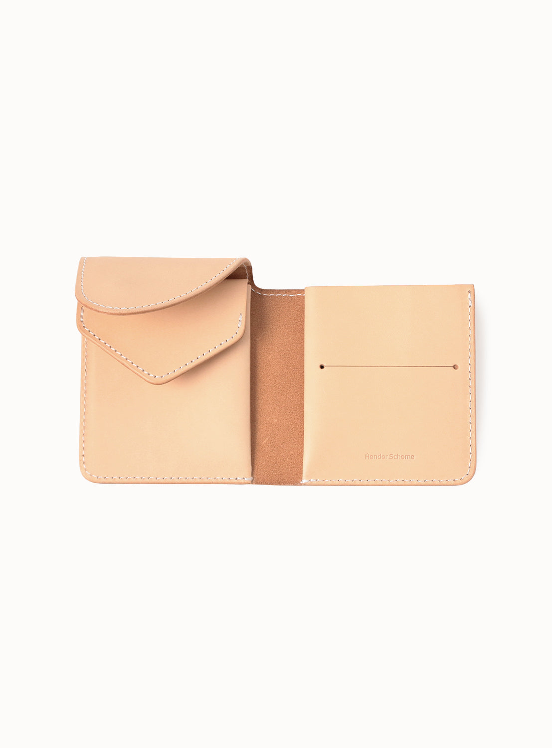 The Hender Scheme Leather Wallet is a tan bridle leather compact with a flap pocket, open center section, and two right card slots. Inside is natural suede, embossed text on the lower right, and it develops a rich patina over time.