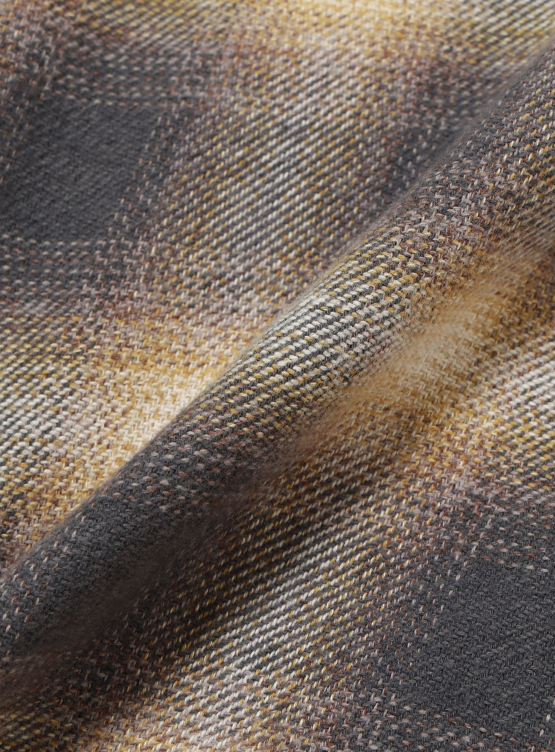 Close-up of a folded Flannel Zip Open Collar Shirt featuring a blurred brown, gray, and cream check pattern.