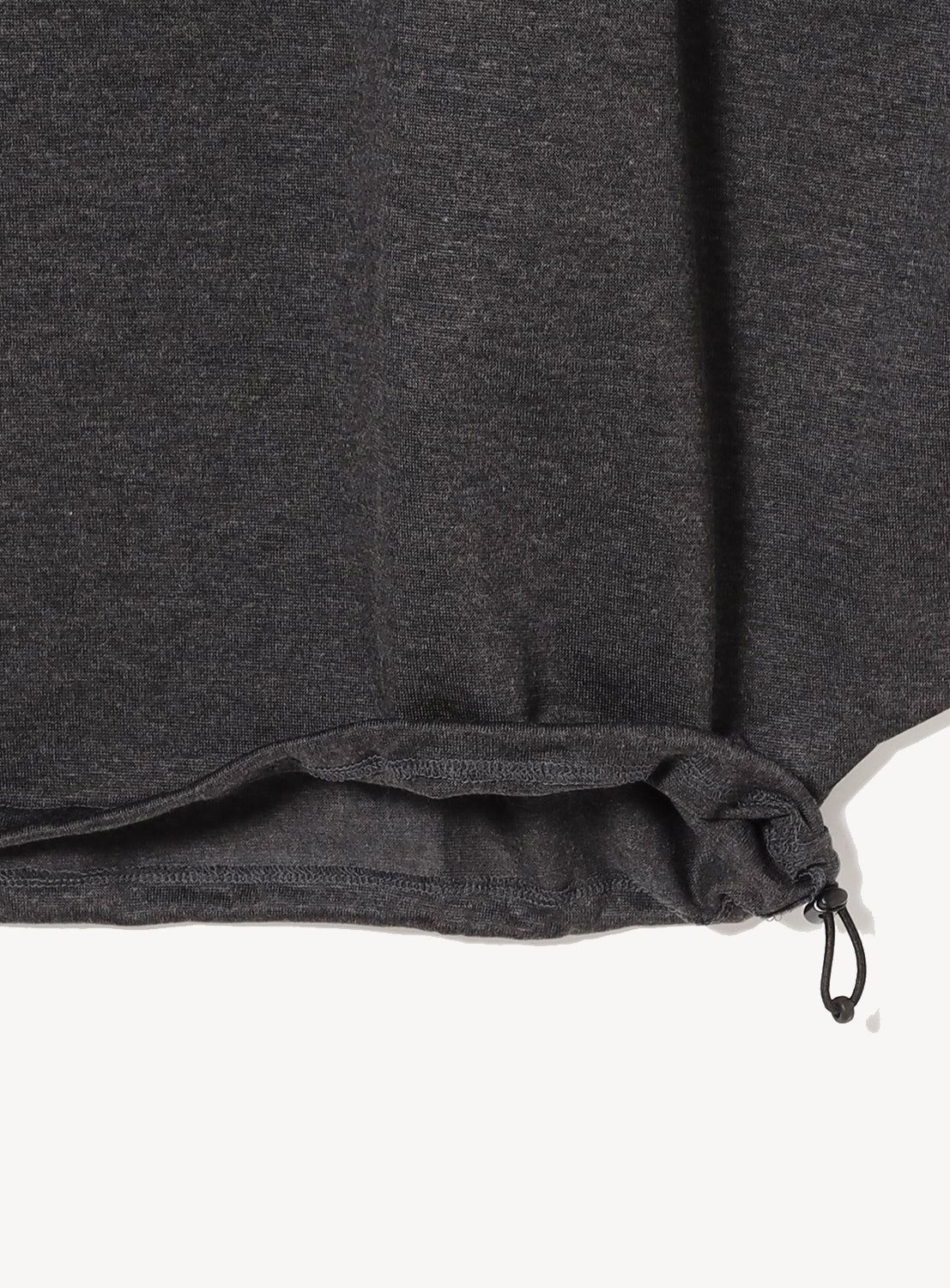 Close-up of a dark gray drawstring detail. 