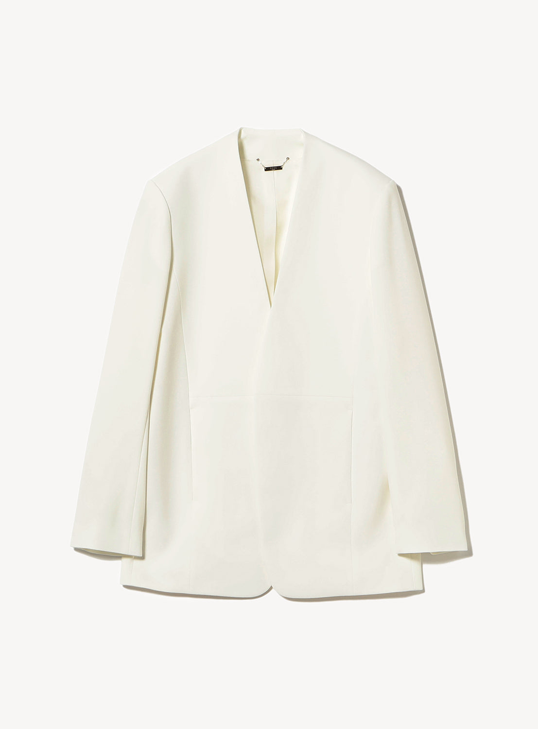 A minimalist white blazer with a deep V-neckline, structured shoulders, and a sleek, collarless design, displayed flat on a white background.