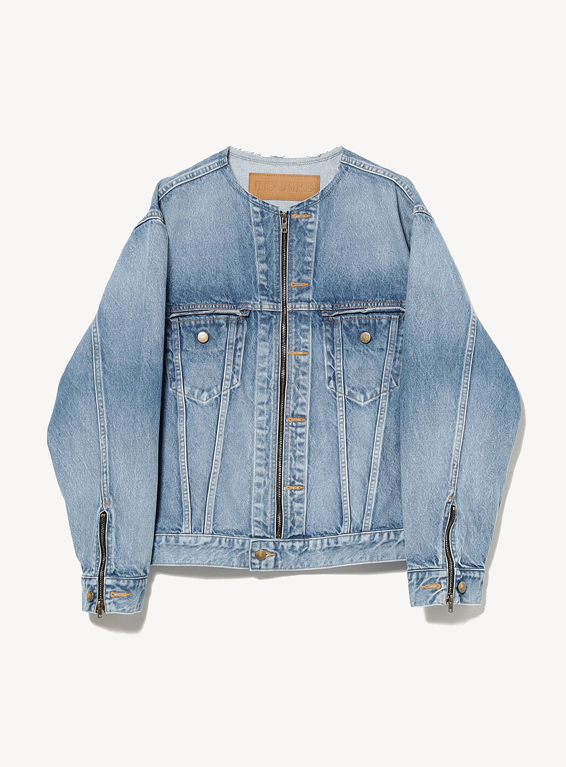 INSCRIRE’s Used Collarless Denim Zip Jacket is crafted from heavyweight cotton denim in a light blue vintage wash. This collarless jacket features long sleeves with zippered cuffs, front snap buttons, flap chest pockets, and a slightly faded, retro-inspired look.
