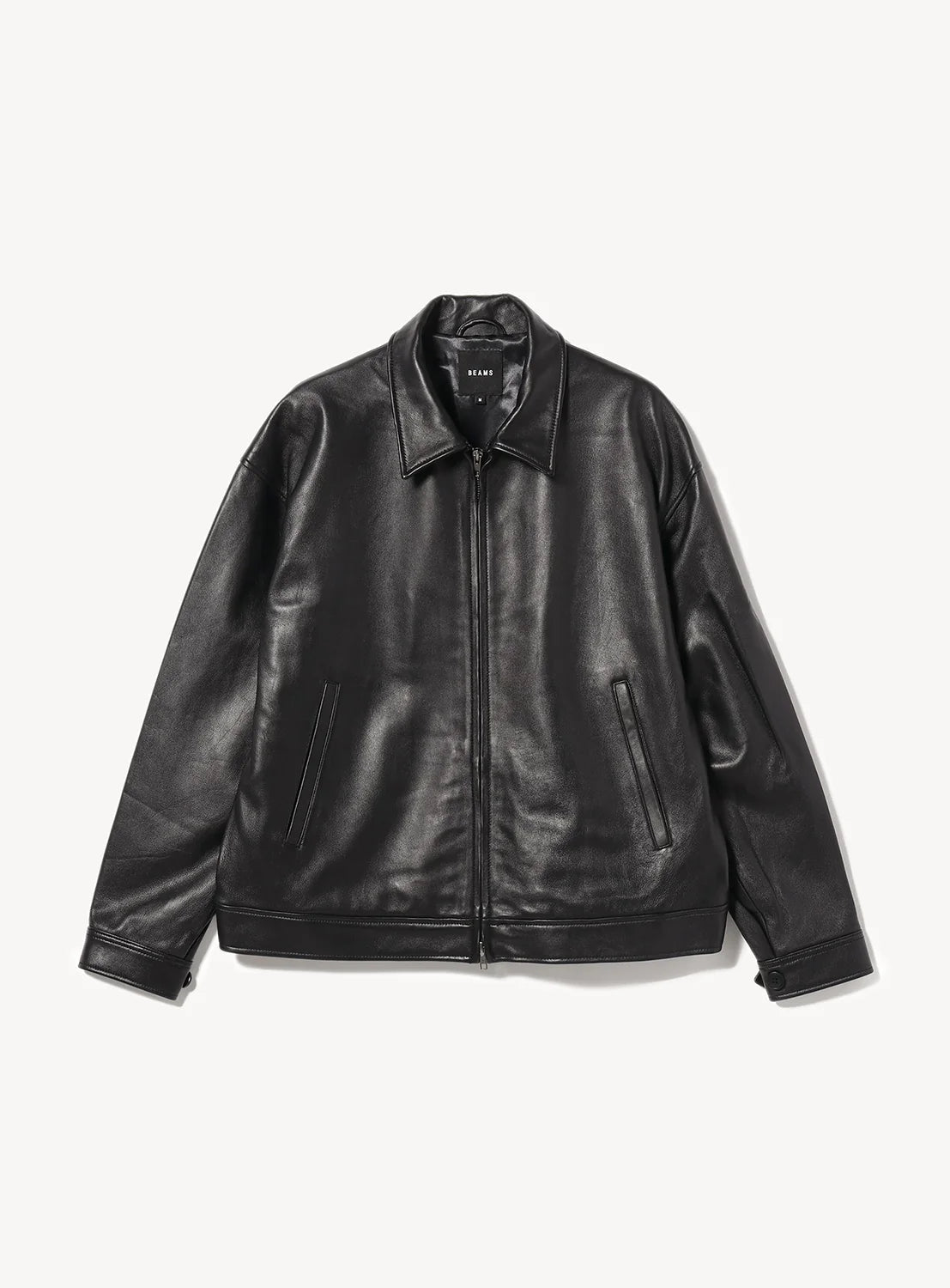 A black leather jacket with a front zipper, collar, and two slanted side pockets, laid flat on a white background.
