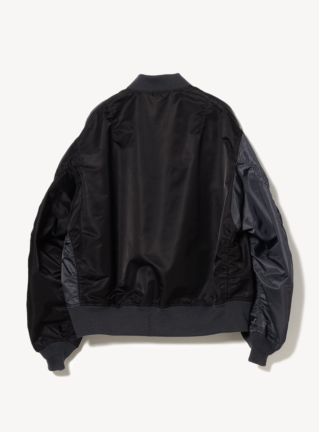 Overhead shot of a black Water-Repellent Wide-Fit MA-1 Bomber Jacket, emphasizing ribbed cuffs and extended hem detail.