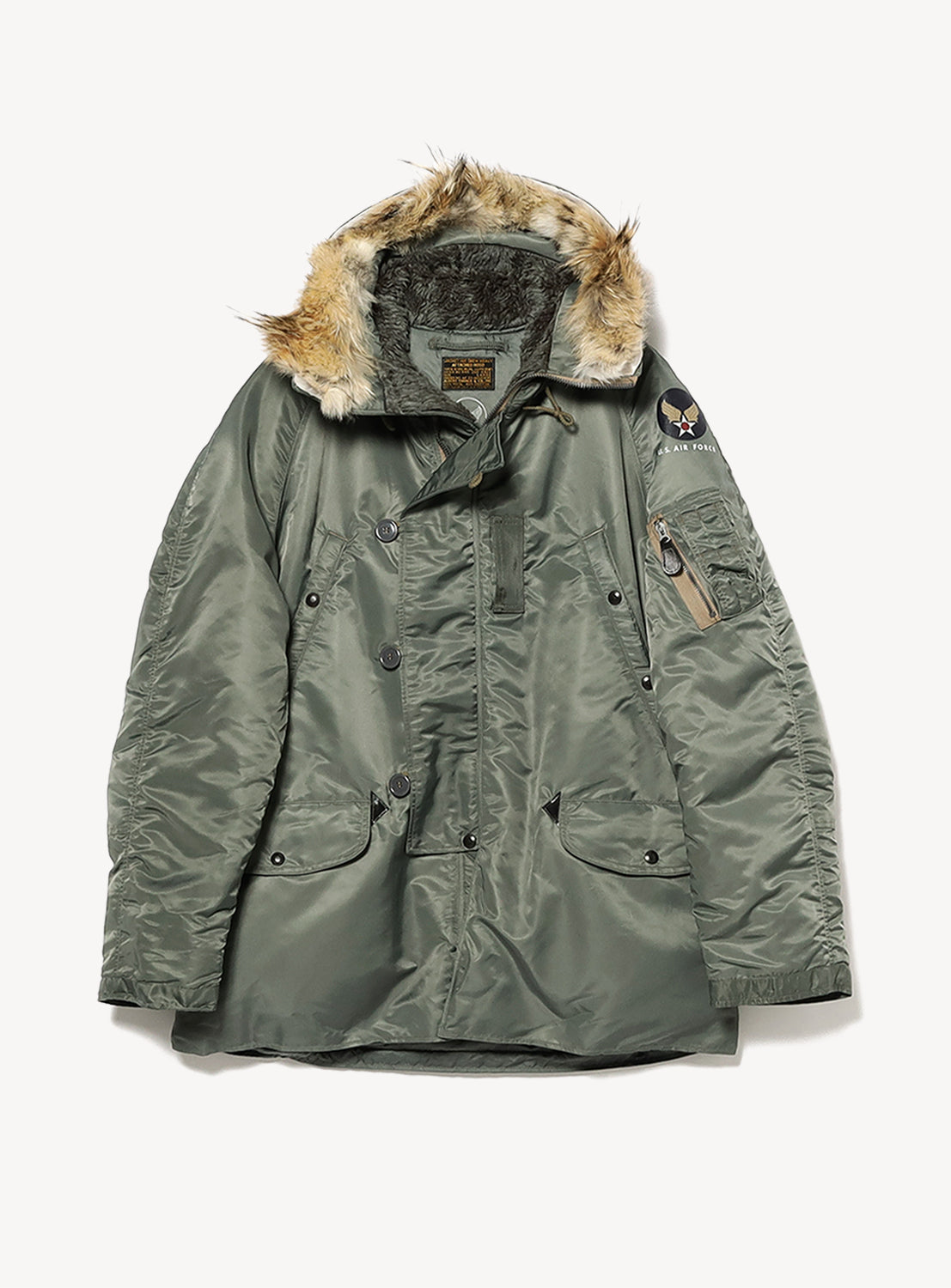 The BUZZ RICKSON’s Type N-3B Coat features an olive green color with a fur-lined hood, button and zip front, two large front pockets, and a patch on the left sleeve—this cold-weather coat is inspired by the classic heavy-zone flight jacket style, offering exceptional warmth with timeless design.