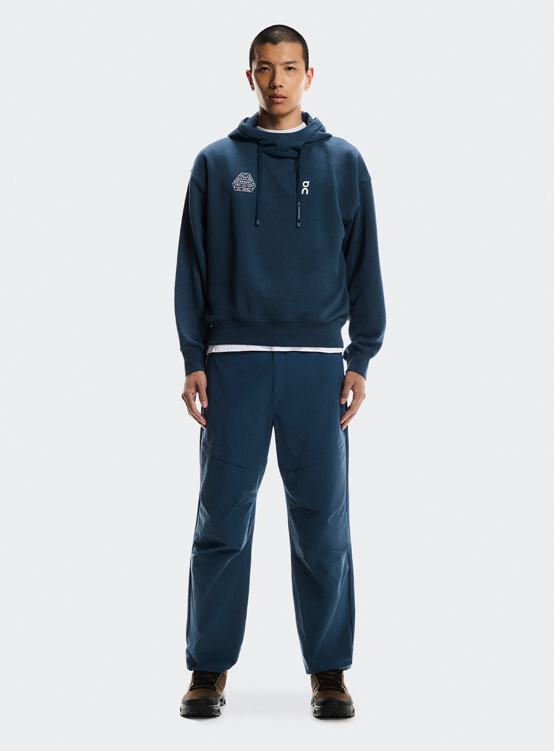 Model wearing a blue hoodie and pants set. 