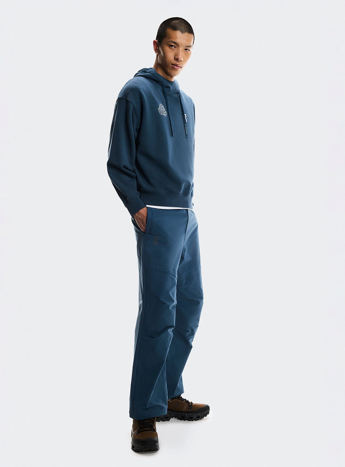 Model wearing a blue hoodie and pants set. 