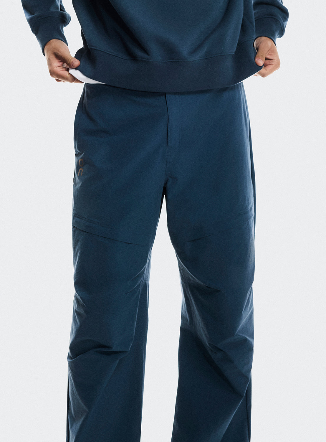 Close up of the blue trek pants, highlighting the details. 