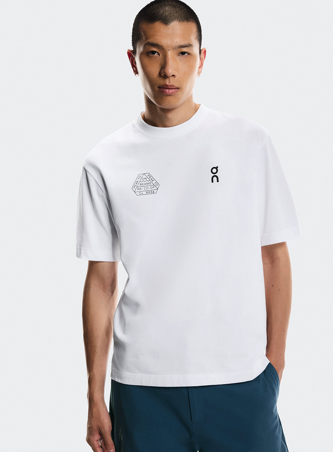 Models wearing a white t-shirt with ON Running, BEAMS, and REI CO-OP logos.