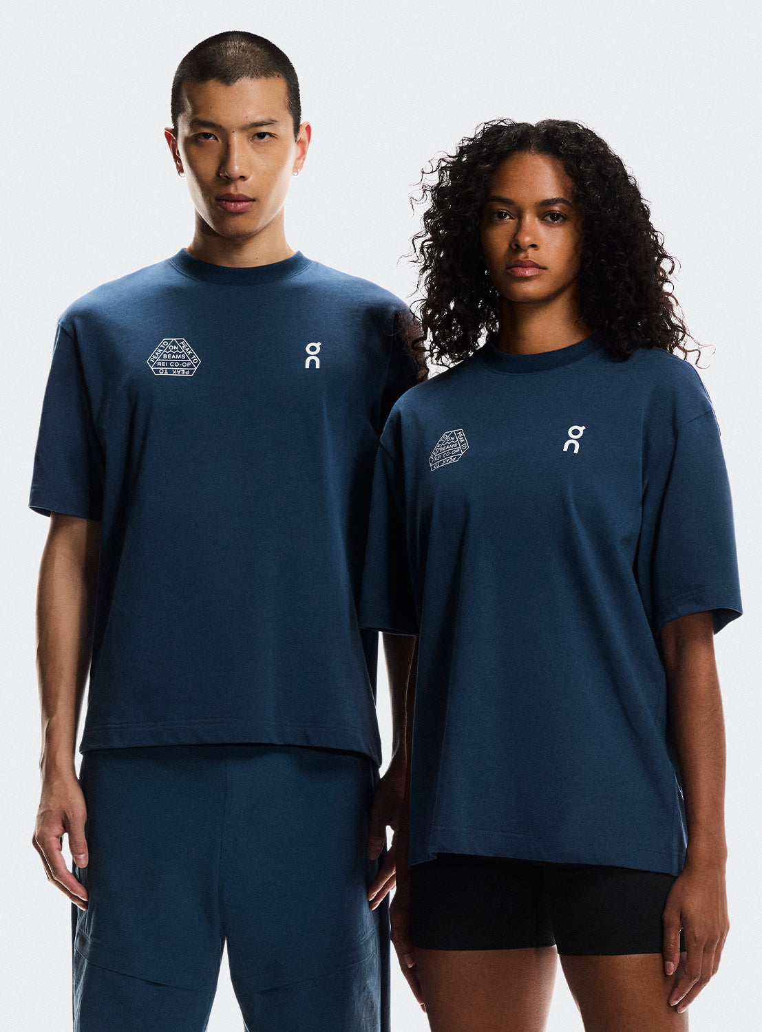 Models wearing navy blue t-shirt with On Running and BEAMS x REI CO-OP logo.