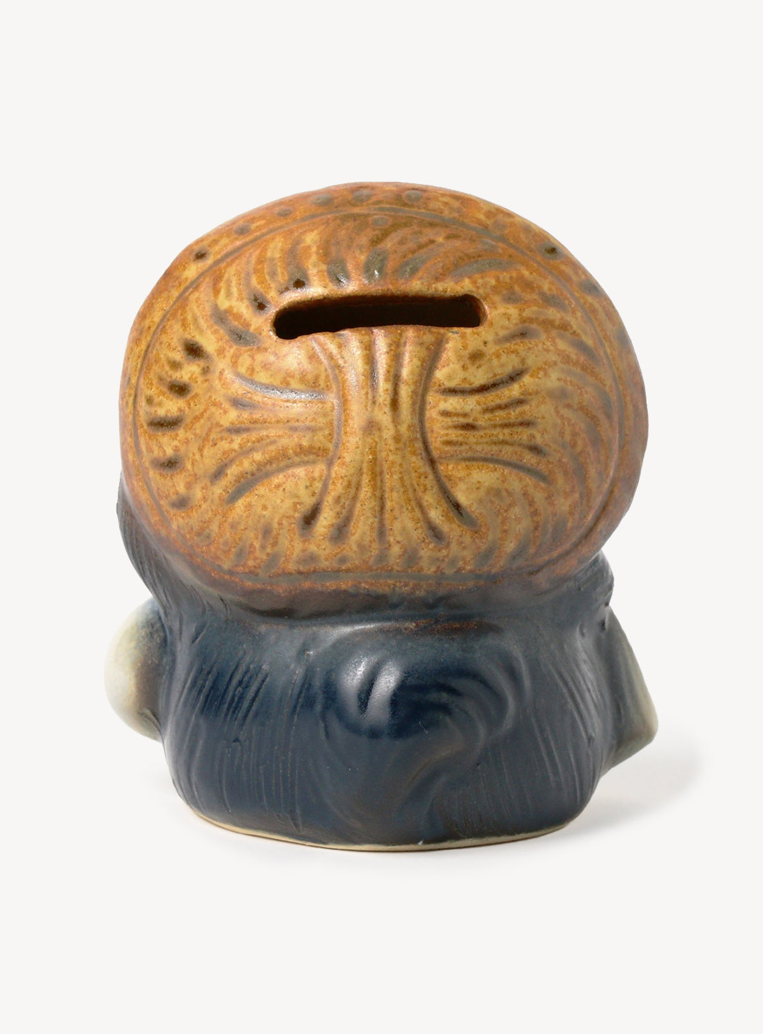 Ceramic money box with a textured surface on a white background