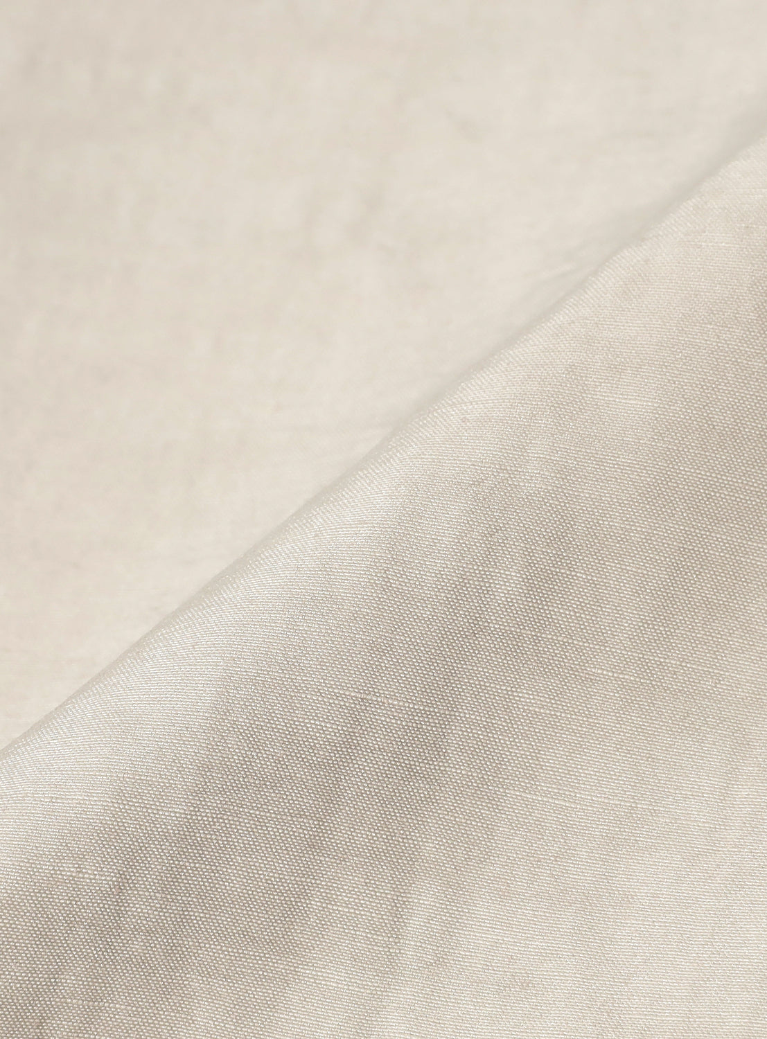 Close-up of the oyster-colored material, highlighting the texture and quality of the pants.