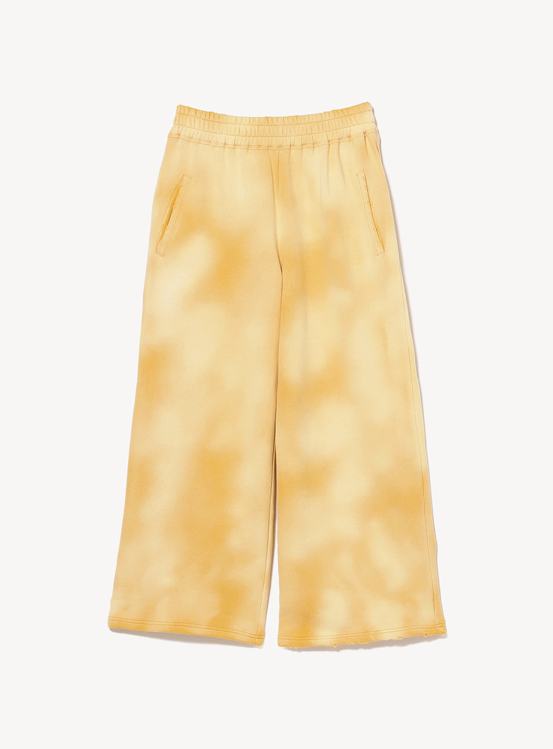 The INSCRIRE Yellow Faded Sweat Wide Pants are vintage-inspired, wide-leg sweatpants featuring an elastic waistband and pockets. Crafted from soft loopback cotton with a yellow and white tie-dye pattern, they are shown laid flat on a white background.