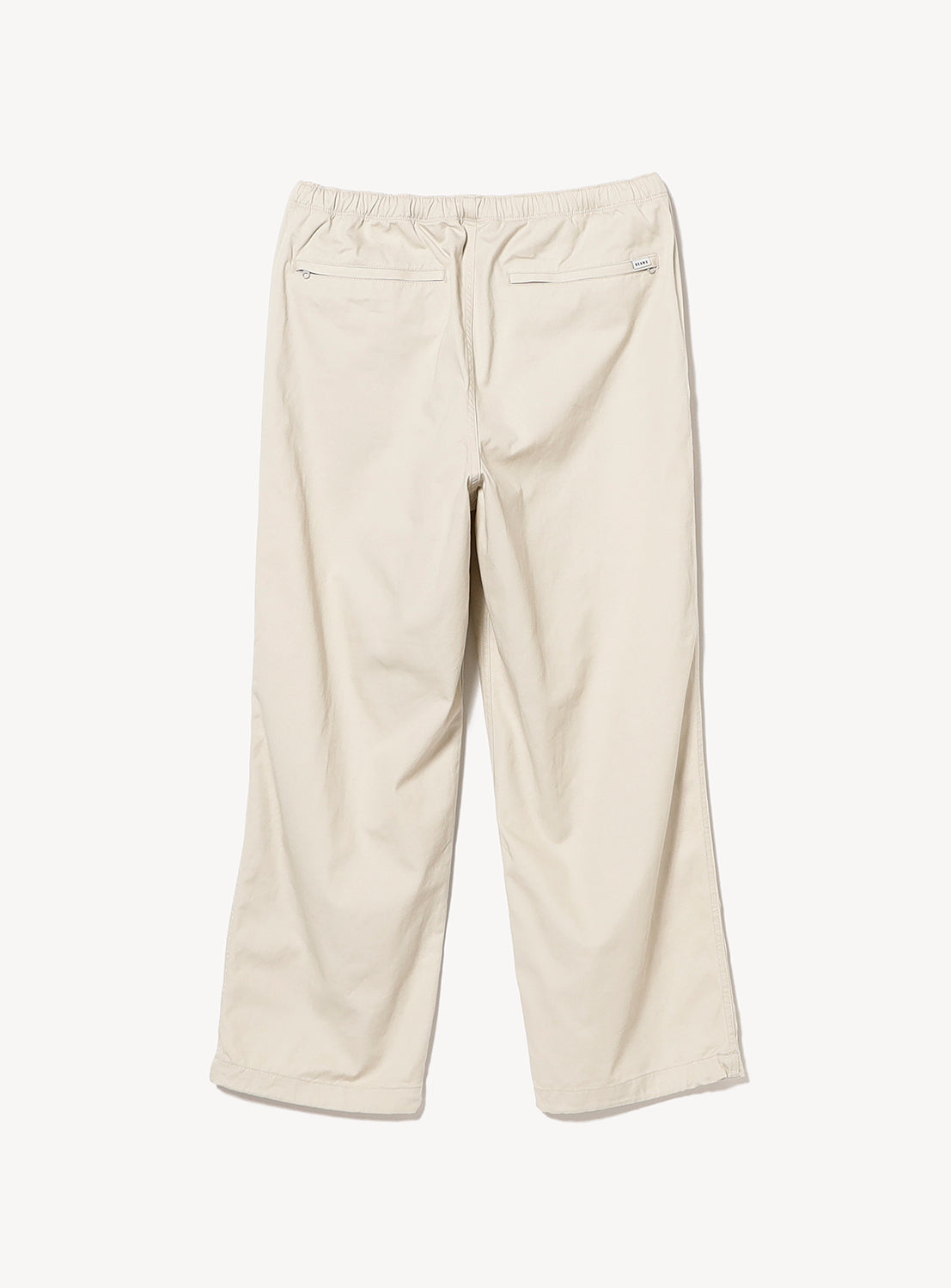 The BEAMS Basic Twill Easy Pants in beige feature a relaxed fit, an adjustable elastic waistband, and two back pockets, shown laid flat on a white background.