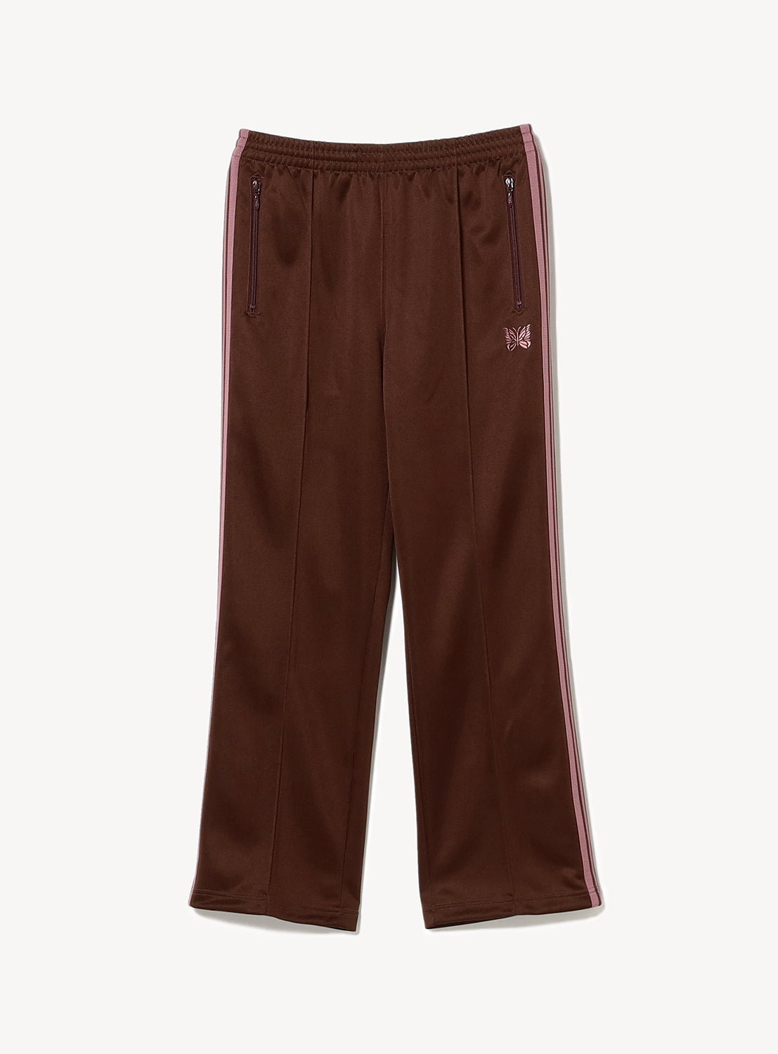 Brown/burgundy track pants with pink stripes on the side, two zipper pockets and a pink embroidered butterfly. 