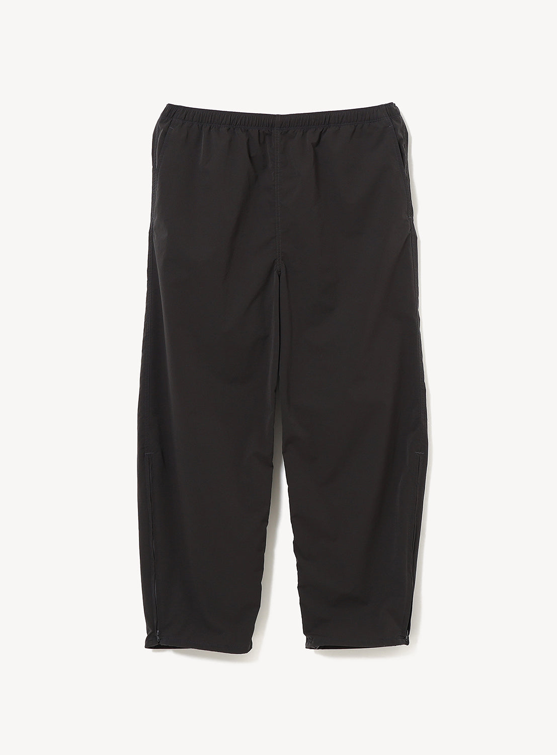Black BEAMS Technical 2-Way Adjustable Easy Pants with an elastic waist and adjustable hem zippers at the bottom of the legs.